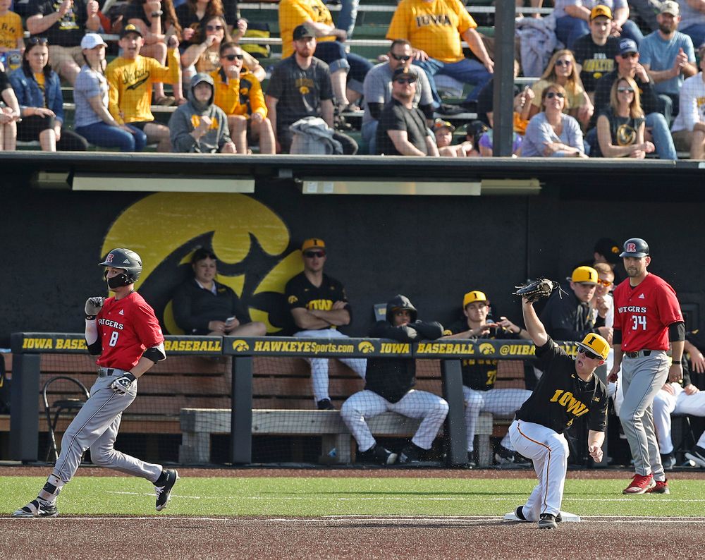 Iowa Hawkeyes first baseman Zeb Adreon (5) holds up his glove after digging out a throw as they turn a double play during the eighth inning of their game against Rutgers at Duane Banks Field in Iowa City on Saturday, Apr. 6, 2019. (Stephen Mally/hawkeyesports.com)