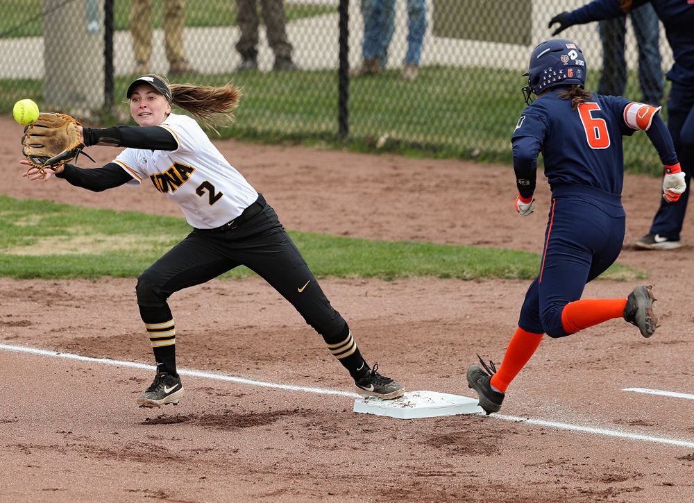 Iowa second baseman Aralee Bogar (2) reaches to pull in a throw as she covers first base on a bunt during the first inning of their game against Illinois at Pearl Field in Iowa City on Friday, Apr. 12, 2019. (Stephen Mally/hawkeyesports.com)