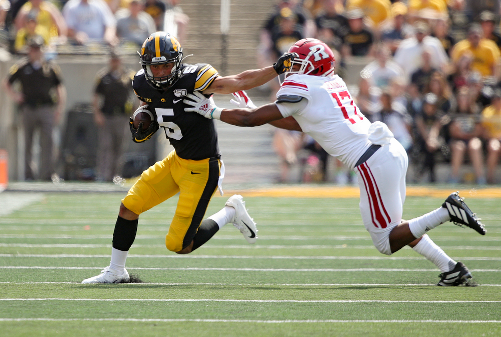 Iowa Hawkeyes wide receiver Oliver Martin (5) stiff-arms a defender after pulling in a pass during the fourth quarter of their Big Ten Conference football game at Kinnick Stadium in Iowa City on Saturday, Sep 7, 2019. (Stephen Mally/hawkeyesports.com)