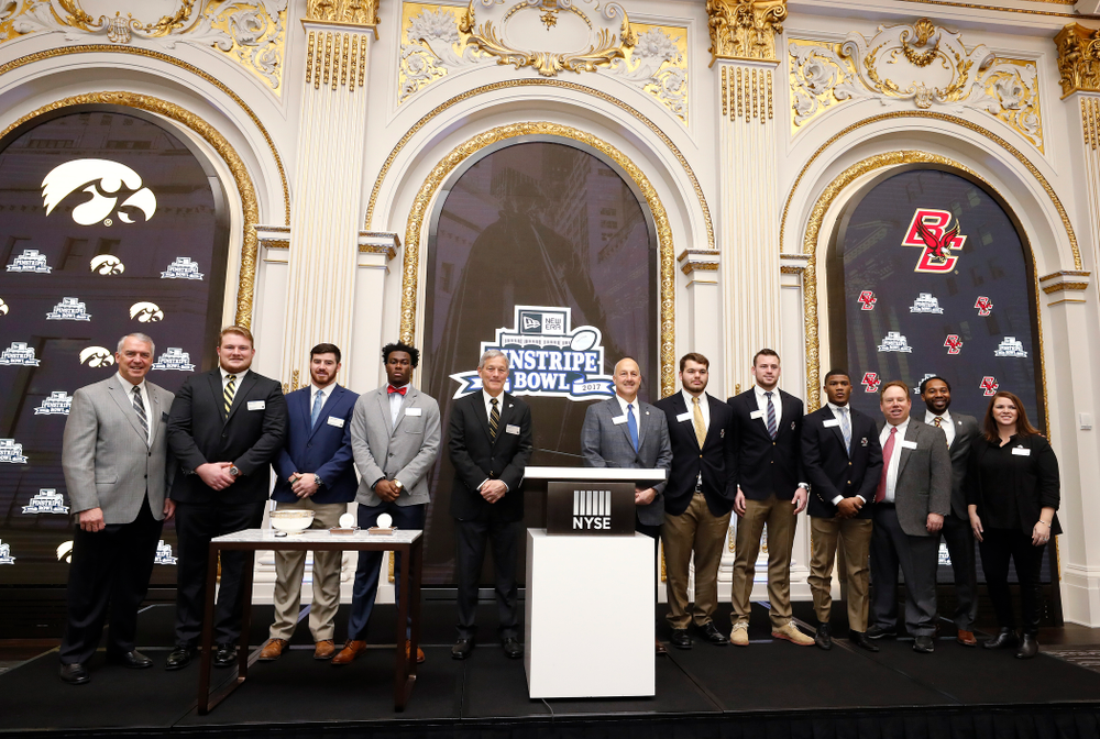 Iowa Hawkeyes linebacker Josey Jewell (43), defensive back Joshua Jackson (15), offensive lineman Sean Welsh (79) and head coach Kirk Ferentz ring the opening bell at the New York Stock Exchange Tuesday, December 26, 2017 in New York. (Brian Ray/hawkeyesports.com)