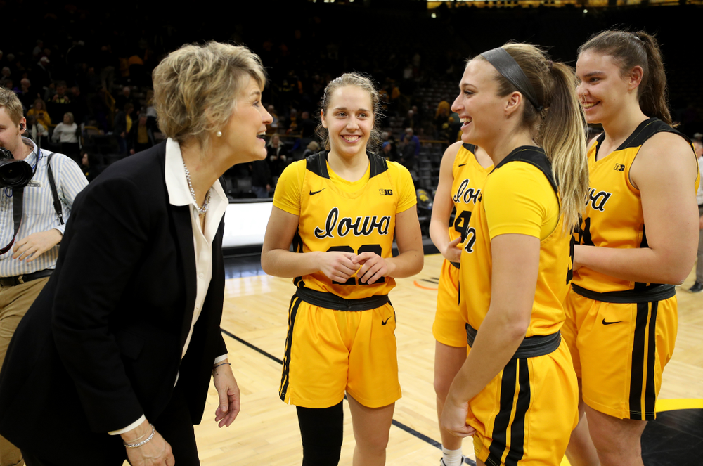 Iowa Hawkeyes head coach Lisa Bluder laughs with seniors Kathleen Doyle, Makenzie Meyer, Amanda Ollinger, and Paula Valiño Ramos during senior day activities following their win over the Minnesota Golden Gophers Thursday, February 27, 2020 at Carver-Hawkeye Arena. (Brian Ray/hawkeyesports.com)