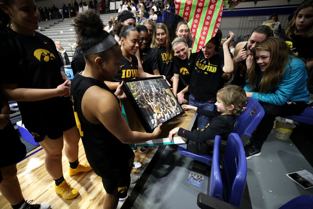 The Iowa Hawkeyes present their adopted team member Harper Stribe a photo for Christmas following their win over the Drake Bulldogs Friday, December 21, 2018 at the Knapp Center in Des Moines. (Brian Ray/hawkeyesports.com)