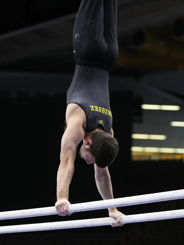 Iowa's Rogelio Vazquez competes on the parallel bars against the Ohio State Buckeyes Saturday, March 16, 2019 at Carver-Hawkeye Arena. (Brian Ray/hawkeyesports.com)