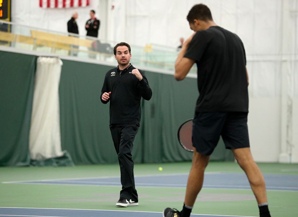 Mellecker Family Head Men's Tennis Coach Ross Wilson (from left) celebrates with Oliver Okonkwo during his singles match at the Hawkeye Tennis and Recreation Complex in Iowa City on Friday, March 6, 2020. (Stephen Mally/hawkeyesports.com)