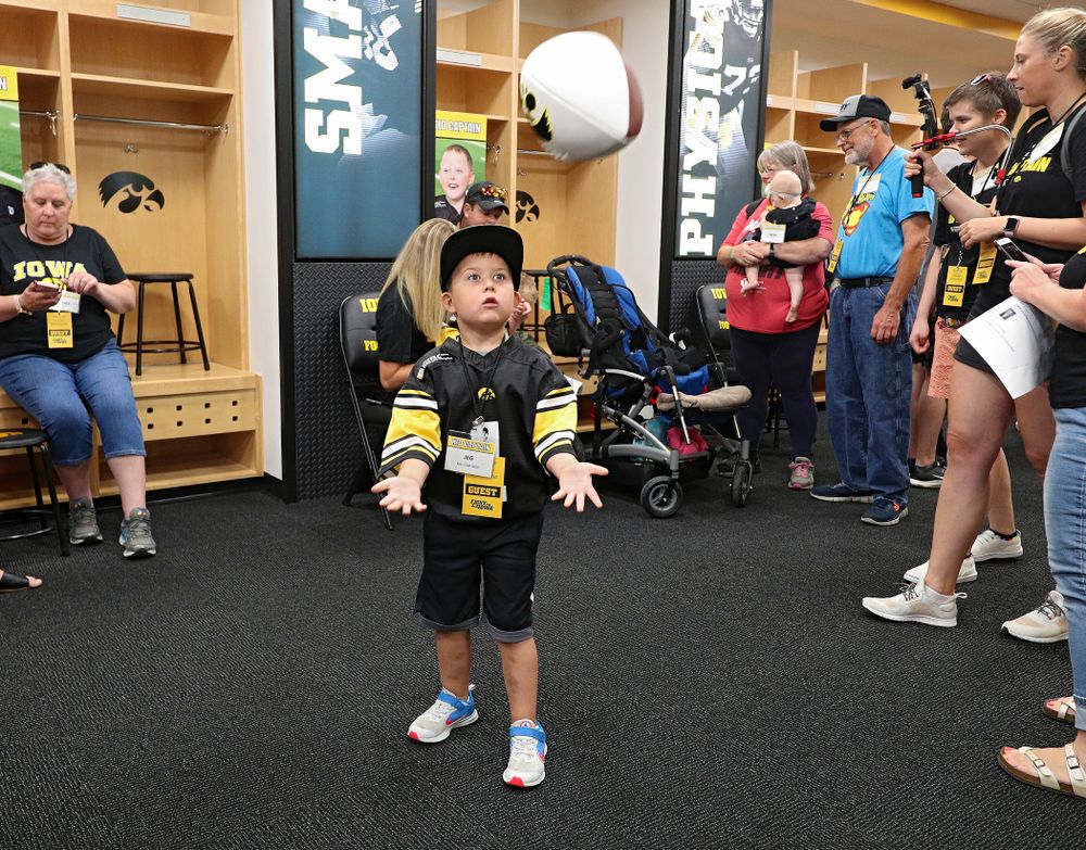 Kid Captain Jeg Weets plays catch in the Iowa locker room during Kids Day at Kinnick Stadium in Iowa City on Saturday, Aug 10, 2019. (Stephen Mally/hawkeyesports.com)