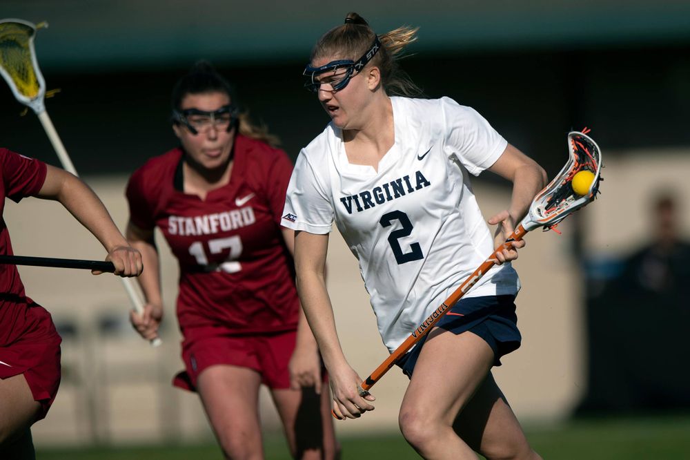 STANFORD, California - FEBRUARY 14: Virginia Cavaliers midfield Sammy Mueller (2) carries the ball past Stanford Cardinal attack Katherine Gjertsen (17) during the first half at Cagan Stadium on February 14, 2020 in Stanford, California. The Virginia Cavaliers defeated the Stanford Cardinal 12-11. (Photo by Jason O. Watson)