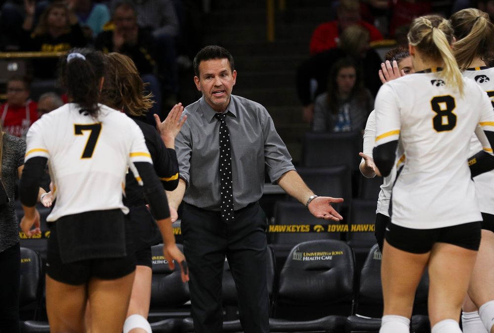 Iowa Hawkeyes head coach Bond Shymansky high fives players during a timeout during a match against Nebraska at Carver-Hawkeye Arena on November 7, 2018. (Tork Mason/hawkeyesports.com)