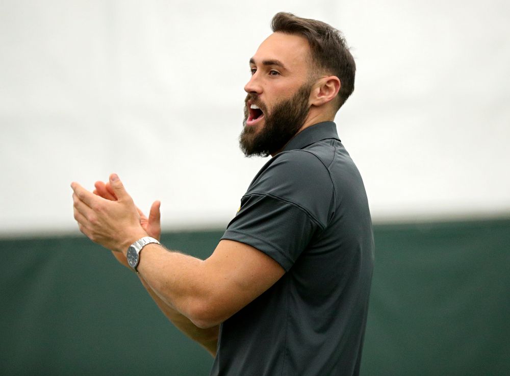 Iowa’s assistant coach Lloyd Bruce-Burgess claps as he urges on his players on during a singles match at the Hawkeye Tennis and Recreation Complex in Iowa City on Friday, February 14, 2020. (Stephen Mally/hawkeyesports.com)