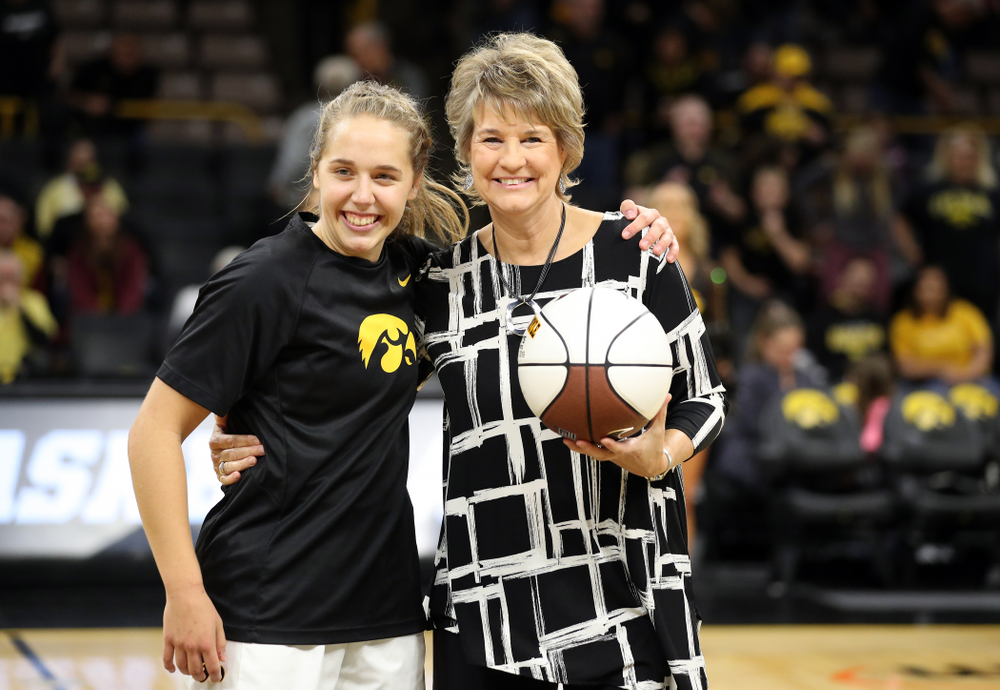 Iowa Hawkeyes guard Kathleen Doyle (22) receives a commemorative ball from Iowa Hawkeyes head coach Lisa Bluder before their game against North Alabama Thursday, November 14, 2019 at Carver-Hawkeye Arena. (Brian Ray/hawkeyesports.com)