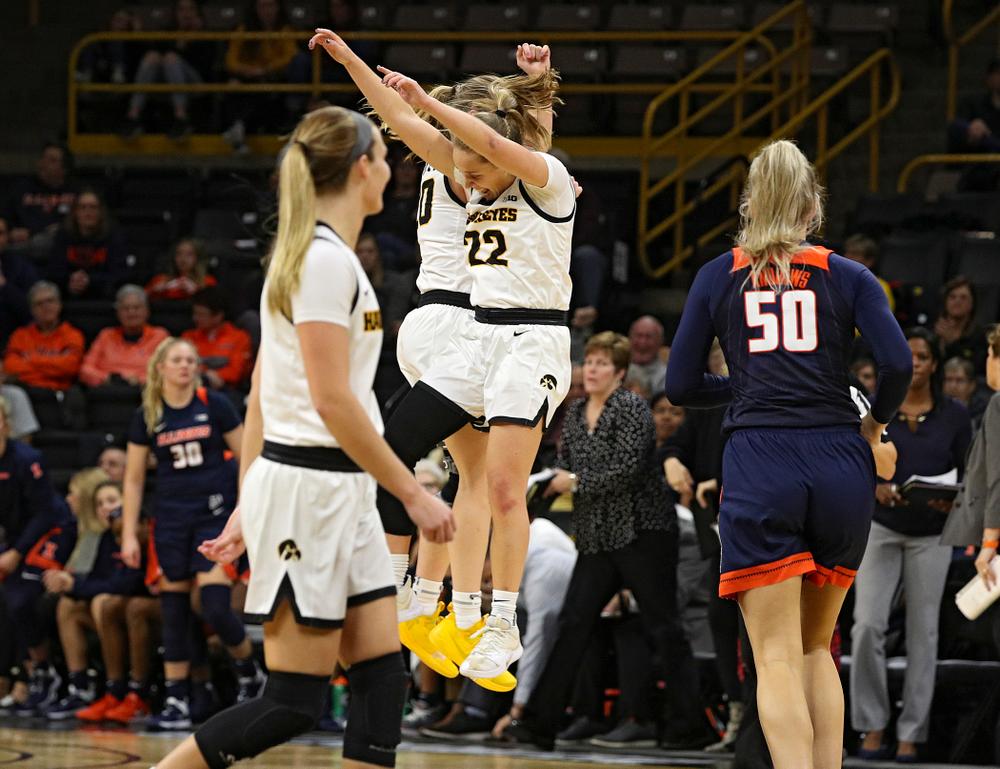 Iowa Hawkeyes guard Kate Martin (20) and guard Kathleen Doyle (22) celebrate during the fourth quarter of their game at Carver-Hawkeye Arena in Iowa City on Tuesday, December 31, 2019. (Stephen Mally/hawkeyesports.com)