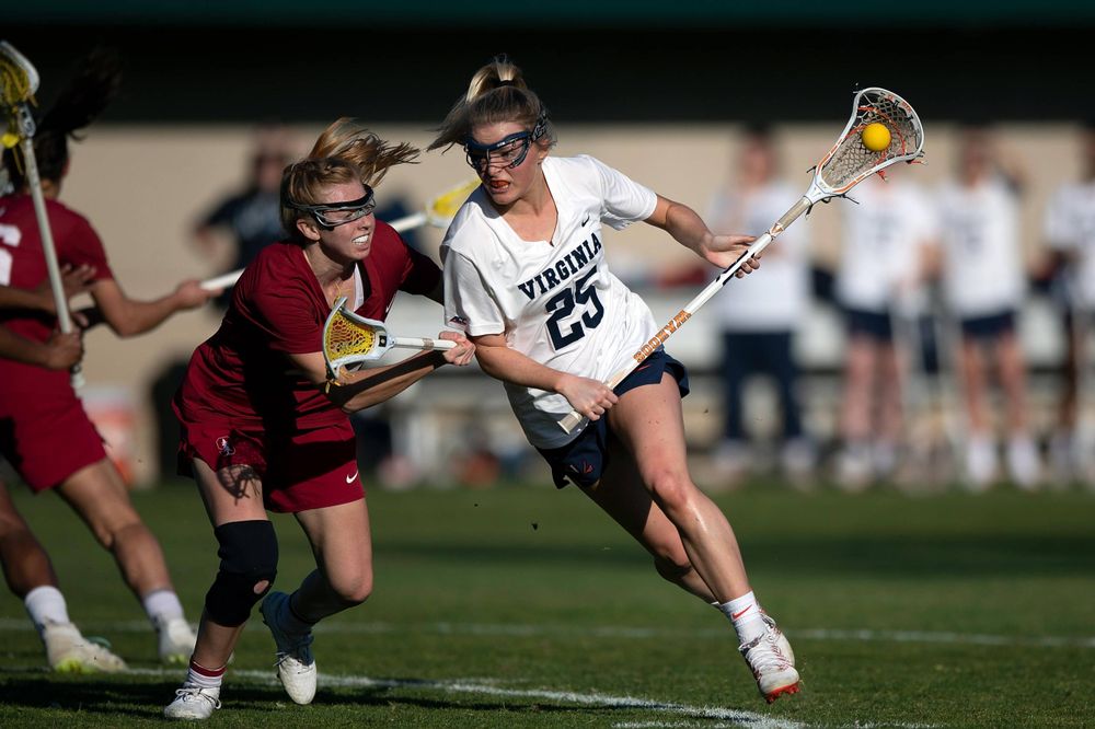 STANFORD, California - FEBRUARY 14: Virginia Cavaliers midfield Courtlynne Caskin (25) is defended by Stanford Cardinal midfield Jacie Lemos (33) during the first half at Cagan Stadium on February 14, 2020 in Stanford, California. The Virginia Cavaliers defeated the Stanford Cardinal 12-11. (Photo by Jason O. Watson)