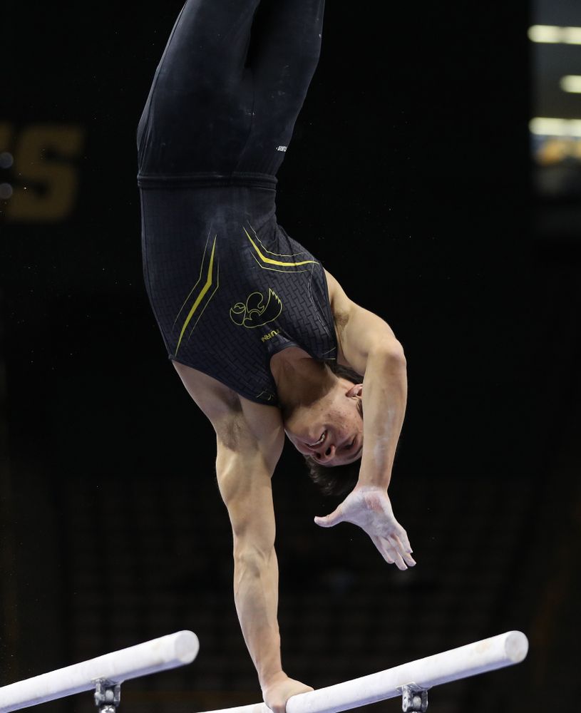 Iowa's Evan Davis competes on the parallel bars against the Ohio State Buckeyes Saturday, March 16, 2019 at Carver-Hawkeye Arena. (Brian Ray/hawkeyesports.com)