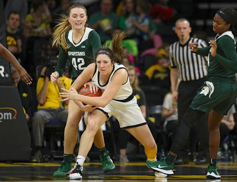 Iowa Hawkeyes guard Mckenna Warnock (14) is fouled after grabbing a rebound during the fourth quarter of their game at Carver-Hawkeye Arena in Iowa City on Sunday, January 26, 2020. (Stephen Mally/hawkeyesports.com)