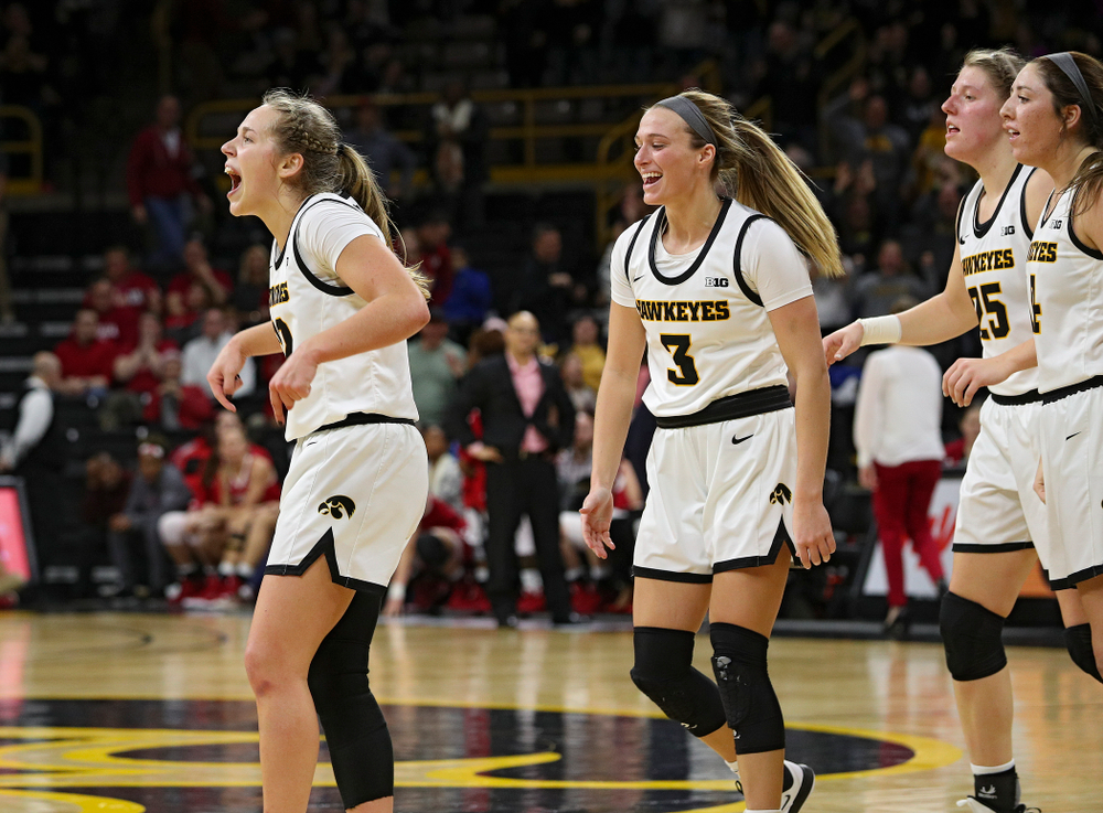 Iowa Hawkeyes guard Kathleen Doyle (22) celebrates with guard Makenzie Meyer (3), forward Monika Czinano (25), and guard Mckenna Warnock (14), after making a basket while being fouled during the fourth quarter of their game at Carver-Hawkeye Arena in Iowa City on Sunday, January 12, 2020. (Stephen Mally/hawkeyesports.com)