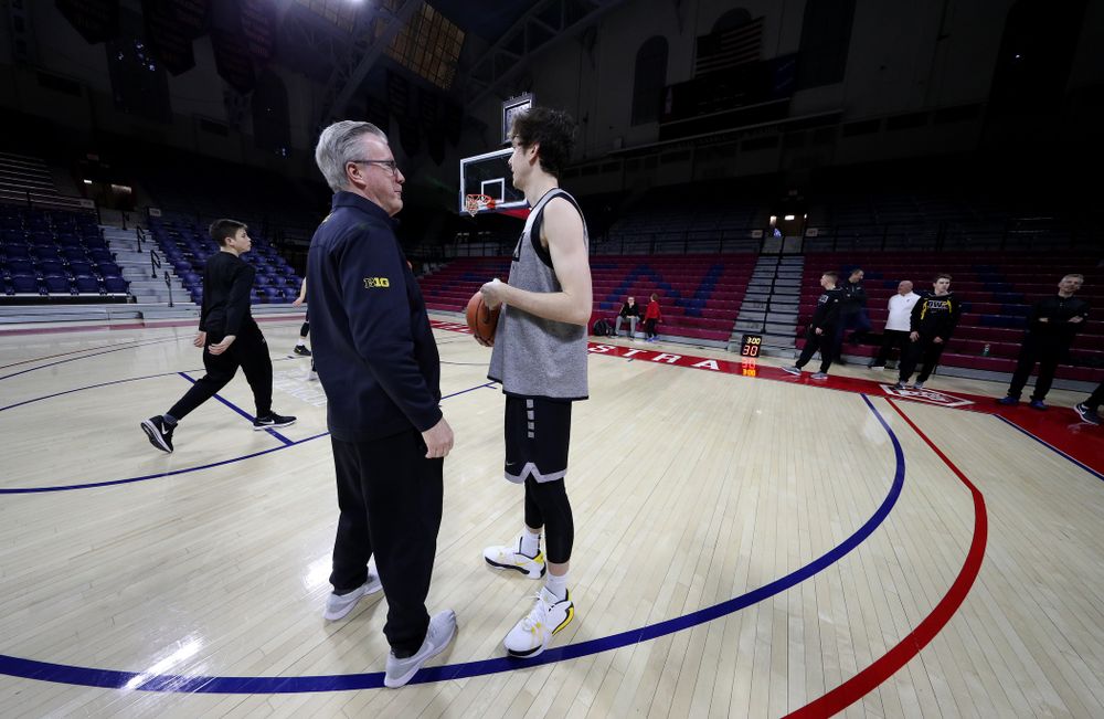 Iowa Hawkeyes head coach Fran McCaffery talks with Iowa Hawkeyes forward Patrick McCaffery (22) before practice at the Palestra Friday, January 3, 2020 in Philadelphia. (Brian Ray/hawkeyesports.com)