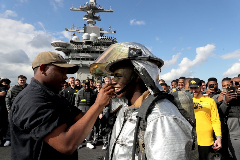 Iowa Hawkeyes running back Keontae Luckett (20) puts on a firefighting suit during a tour of the USS Theodore Roosevelt (CVN-71) Tuesday, December 24, 2019 at the Naval Base Coronado. (Brian Ray/hawkeyesports.com)