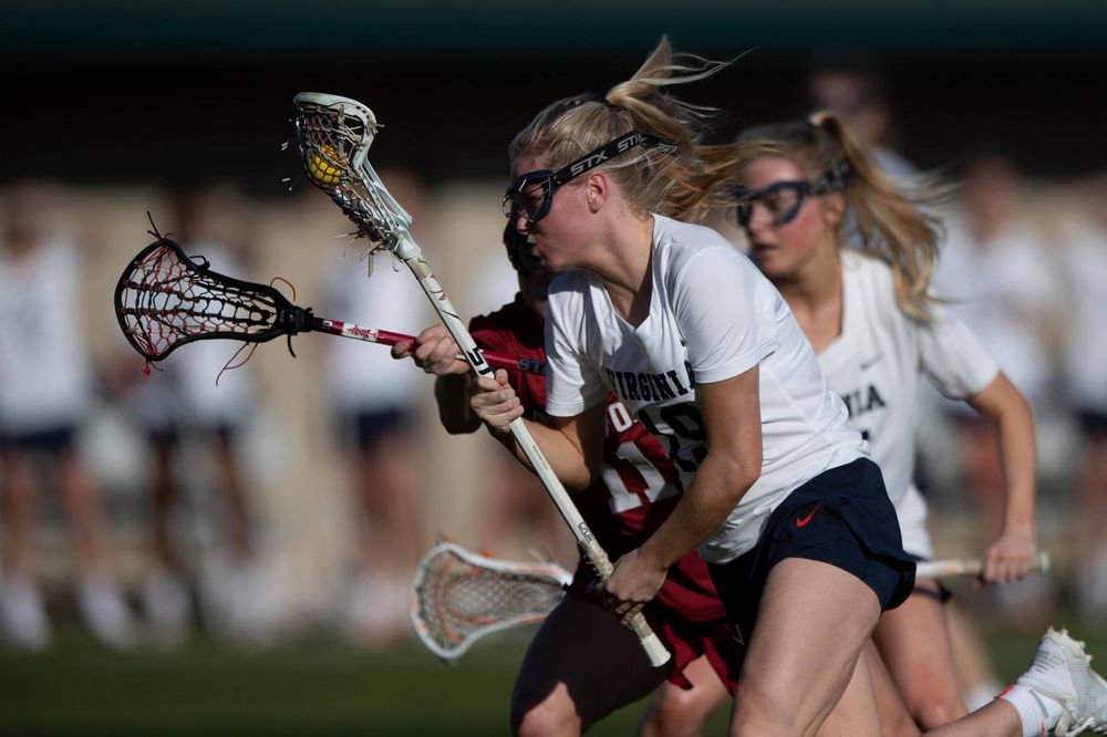 STANFORD, California - FEBRUARY 14: Virginia Cavaliers midfield Annie Dyson (19) is defended by Stanford Cardinal defense Maggie Bellaschi (11) during the first half at Cagan Stadium on February 14, 2020 in Stanford, California. The Virginia Cavaliers defeated the Stanford Cardinal 12-11. (Photo by Jason O. Watson)