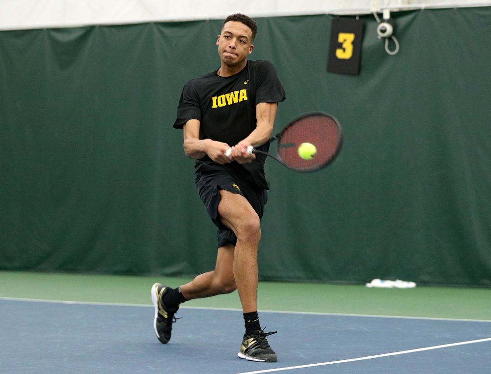 Iowa’s Oliver Okonkwo returns a shot during his singles match at the Hawkeye Tennis and Recreation Complex in Iowa City on Friday, February 14, 2020. (Stephen Mally/hawkeyesports.com)