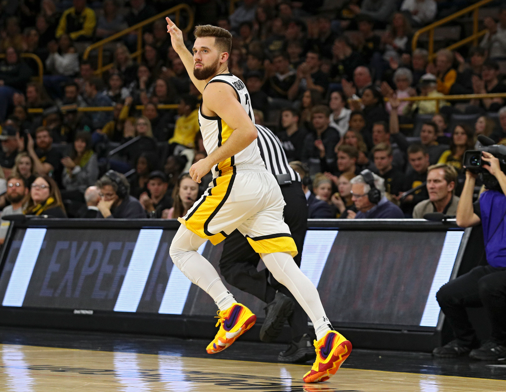 Iowa Hawkeyes guard Jordan Bohannon (3) holds up three fingers as he runs down the court after making a 3-pointer during the first half of their game at Carver-Hawkeye Arena in Iowa City on Friday, Nov 8, 2019. (Stephen Mally/hawkeyesports.com)