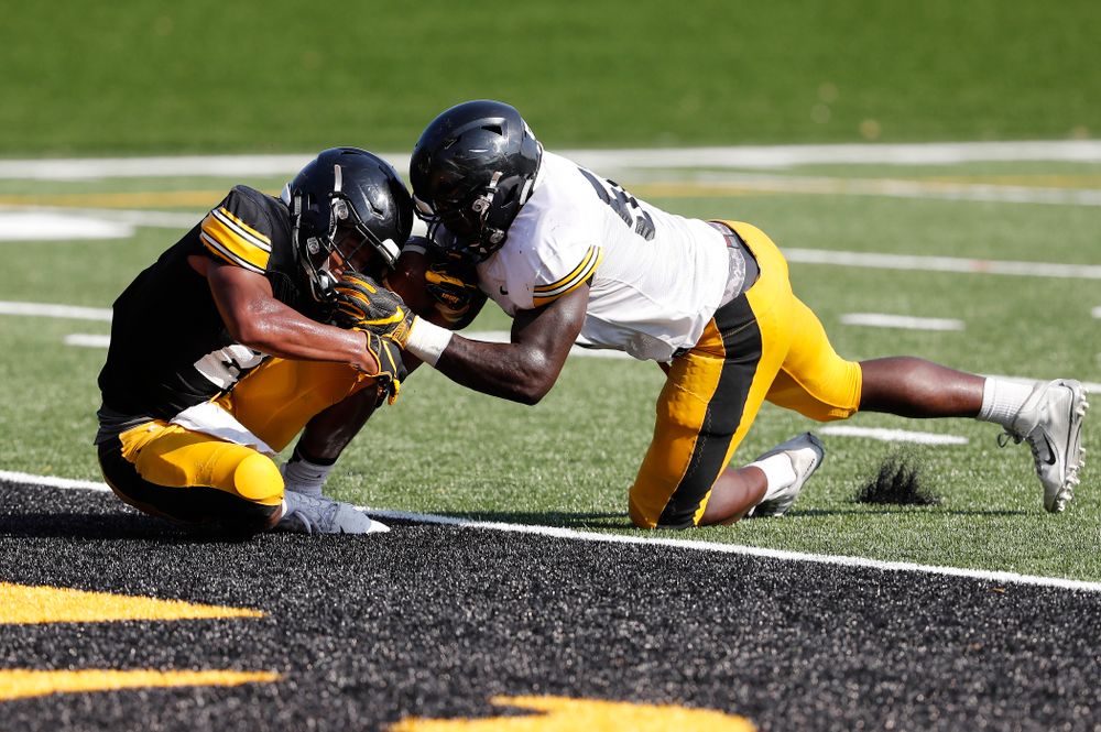 Iowa Hawkeyes running back Ivory Kelly-Martin (21) and linebacker Amani Jones (52) during camp practice No. 17 Wednesday, August 22, 2018 at the Kenyon Football Practice Facility. (Brian Ray/hawkeyesports.com)