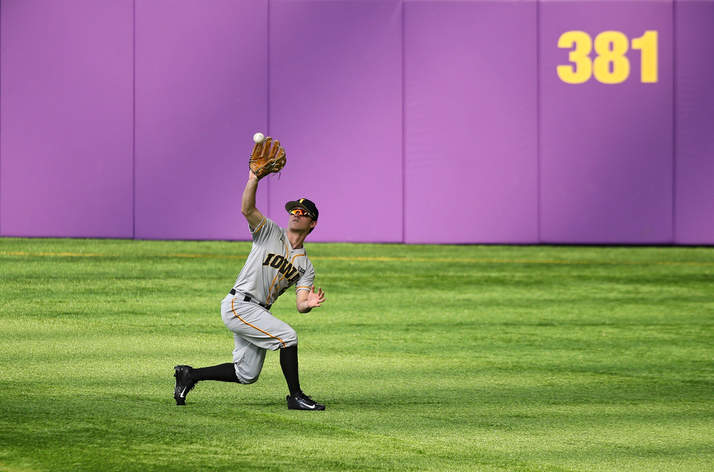 Iowa Hawkeyes outfielder Justin Jenkins (6) pulls in a fly ball for an out during the third inning of their CambriaCollegeClassic game at U.S. Bank Stadium in Minneapolis, Minn. on Friday, February 28, 2020. (Stephen Mally/hawkeyesports.com)
