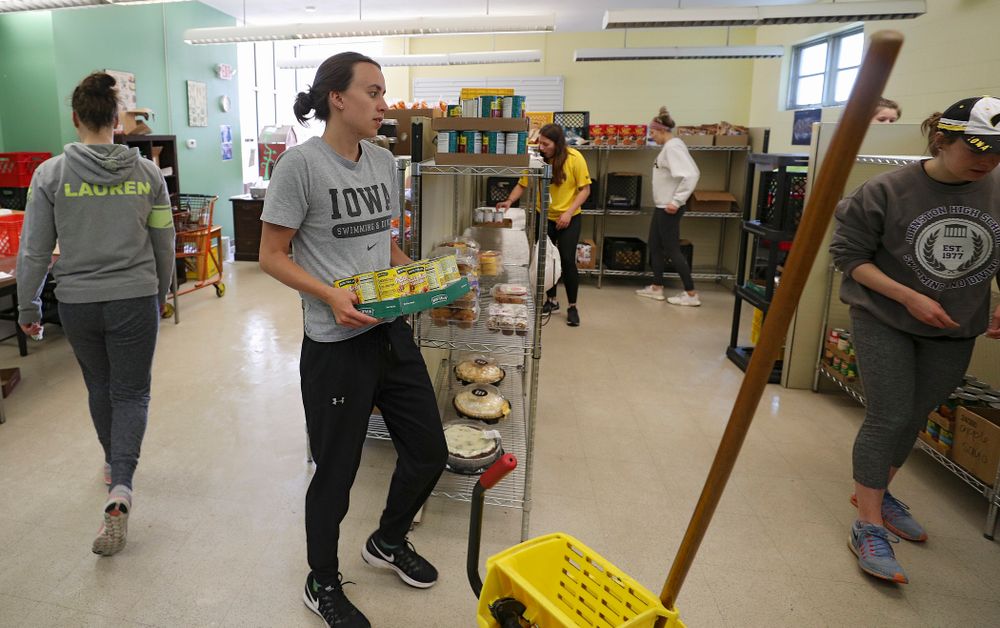 Iowa women's swimming and diving teammates clean the Coralville Community Food Pantry during the 21st annual ISAAC Hawkeye Day of Caring in Coralville on Sunday, Apr. 28, 2019. (Stephen Mally/hawkeyesports.com)