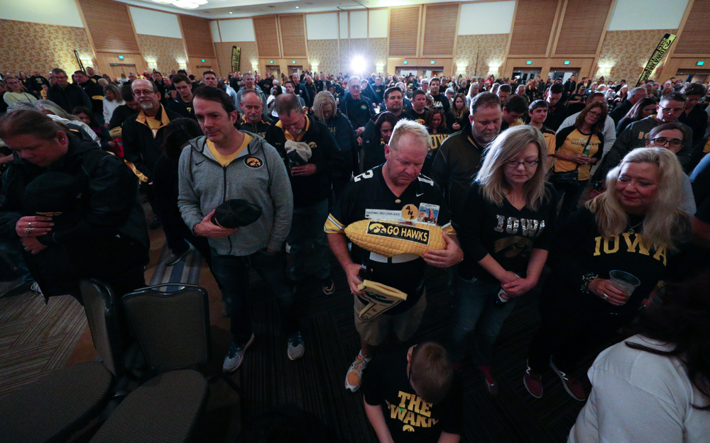 Fans pause for a moment of silence honorary Hayden Fry and Bump Elliott during the Holiday Bowl Hawkeye Huddle Thursday, December 26, 2019 at the Hilton in downtown San Diego. (Brian Ray/hawkeyesports.com)