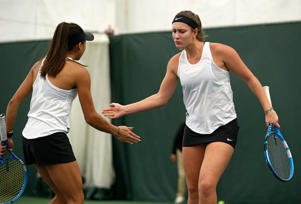 Iowa’s Ashleigh Jacobs (right) celebrates with Michelle Bacalla during their doubles match at the Hawkeye Tennis and Recreation Complex in Iowa City on Sunday, February 23, 2020. (Stephen Mally/hawkeyesports.com)
