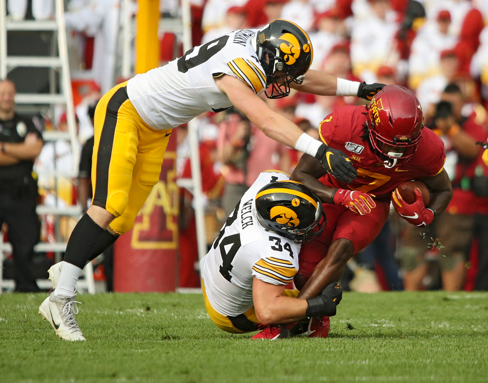 Iowa Hawkeyes linebacker Nick Niemann (49) and linebacker Kristian Welch (34) make a tackle during the first quarter of their Iowa Corn Cy-Hawk Series game at Jack Trice Stadium in Ames on Saturday, Sep 14, 2019. (Stephen Mally/hawkeyesports.com)