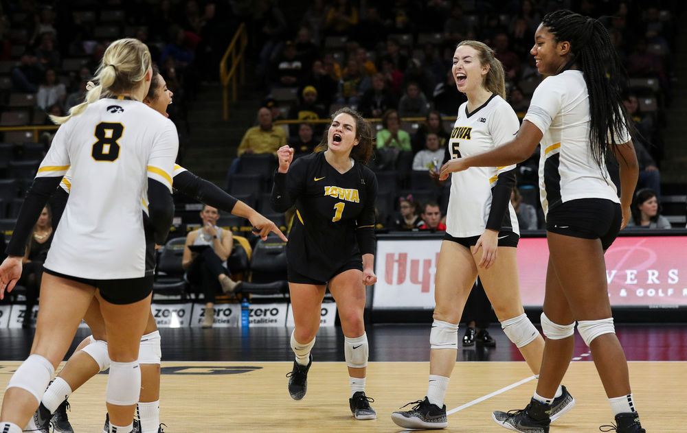 Iowa Hawkeyes defensive specialist Molly Kelly (1), Iowa Hawkeyes outside hitter Meghan Buzzerio (5) and Iowa Hawkeyes middle blocker Amiya Jones (9) celebrate after winning a point during a match against Maryland at Carver-Hawkeye Arena on November 23, 2018. (Tork Mason/hawkeyesports.com)