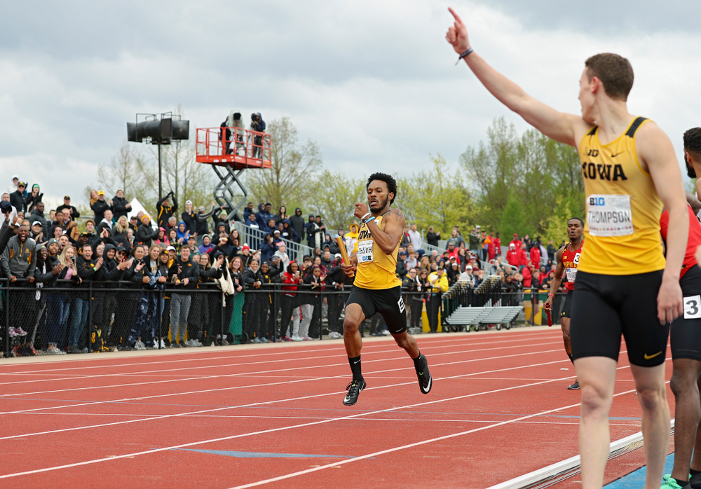 Iowa's Chris Thompson (right) starts to celebrate as May’yea Harris nears the finish line as they win the 1600 meter relay event on the third day of the Big Ten Outdoor Track and Field Championships at Francis X. Cretzmeyer Track in Iowa City on Sunday, May. 12, 2019. (Stephen Mally/hawkeyesports.com)