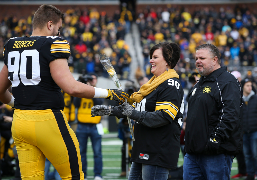 Iowa Hawkeyes defensive end Sam Brincks (90) is greeted by his parents during Senior Day ceremonies before a game against Nebraska at Kinnick Stadium on November 23, 2018. (Tork Mason/hawkeyesports.com)