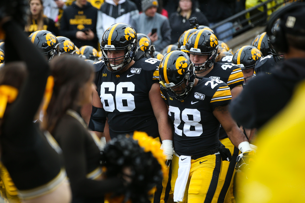 Iowa Hawkeyes offensive lineman Levi Paulsen (66) and running back Toren Young (28) during Iowa football vs Purdue on Saturday, October 19, 2019 at Kinnick Stadium. (Lily Smith/hawkeyesports.com)
