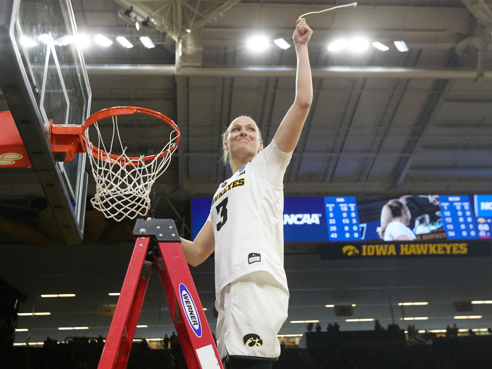 Iowa Hawkeyes guard Makenzie Meyer (3) cuts down the net after winning their second round game in the 2019 NCAA Women's Basketball Tournament at Carver Hawkeye Arena in Iowa City on Sunday, Mar. 24, 2019. (Stephen Mally for hawkeyesports.com)