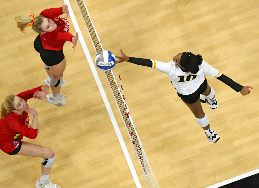 Iowa’s Griere Hughes (10) tips the ball over the net during the second set of their match at Carver-Hawkeye Arena in Iowa City on Saturday, Nov 30, 2019. (Stephen Mally/hawkeyesports.com)