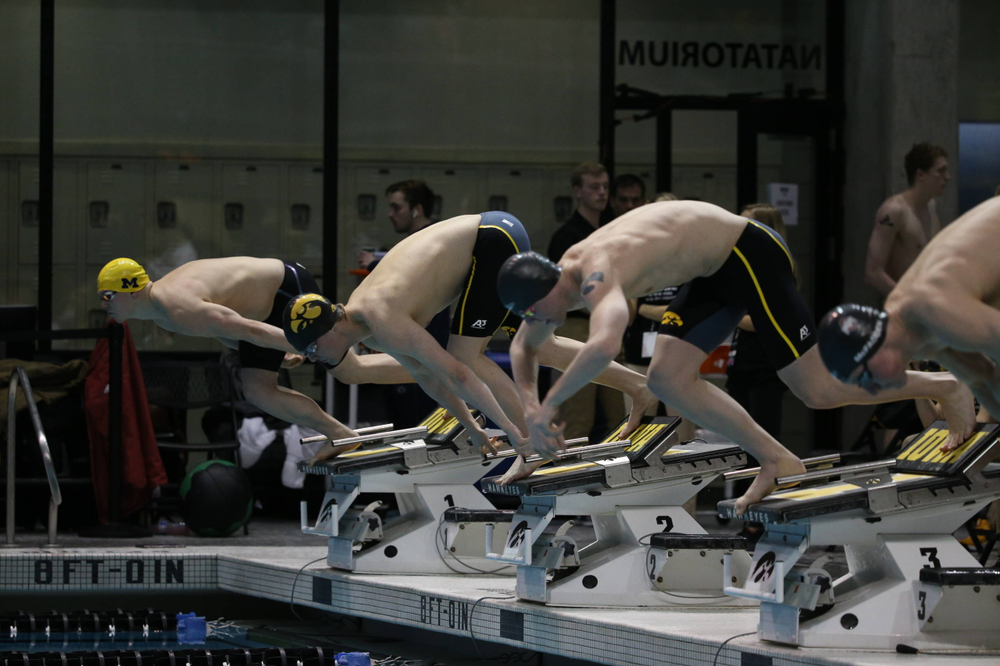Iowa's Caleb Babb (center left) and Tanner Nelson (center right) at the 100-yard breaststroke race Friday, March 1, 2019 at the Campus Recreation and Wellness Center. (Lily Smith/hawkeyesports.com)