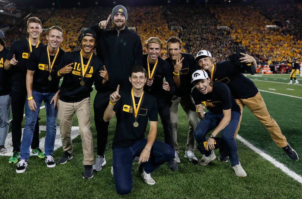 Members of the Iowa men's track and field team are recognized by the Presidential Committee on Athletics at halftime during a game against Wisconsin on September 22, 2018. (Tork Mason/hawkeyesports.com)