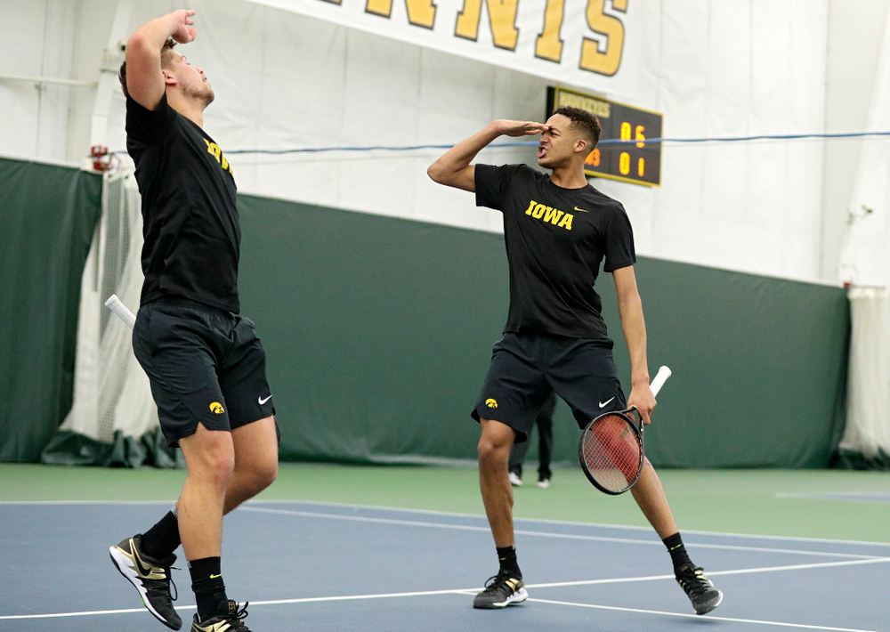 Iowa’s Will Davies (from left) and Oliver Okonkwo celebrate a point during their doubles match at the Hawkeye Tennis and Recreation Complex in Iowa City on Friday, February 14, 2020. (Stephen Mally/hawkeyesports.com)