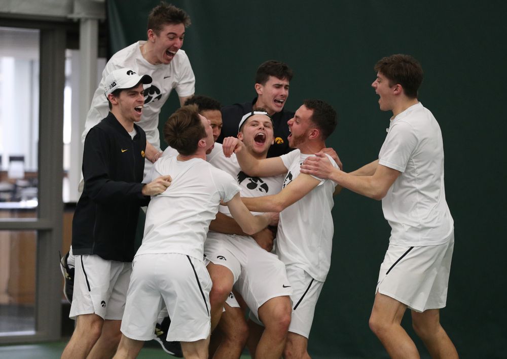 Iowa’s Will Davies celebrates with his teammates after defeating Cornell’s Lev Kazakov in three sets to clench at 4-3 victory Sunday, March 8, 2020 at the Hawkeye Tennis and Recreation Center. (Brian Ray/hawkeyesports.com)