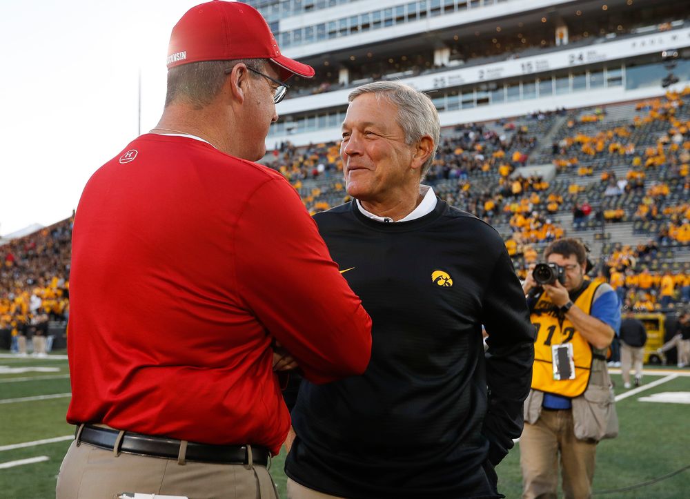 Iowa Hawkeyes head coach Kirk Ferentz meets with Wisconsin Badgers head coach Paul Chryst before a game against Wisconsin at Kinnick Stadium on September 22, 2018. (Tork Mason/hawkeyesports.com)