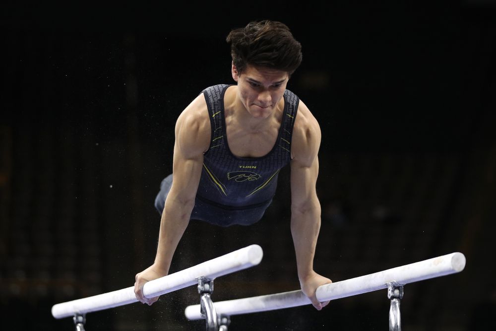 Iowa's Evan Davis competes on the parallel bars against the Ohio State Buckeyes Saturday, March 16, 2019 at Carver-Hawkeye Arena. (Brian Ray/hawkeyesports.com)