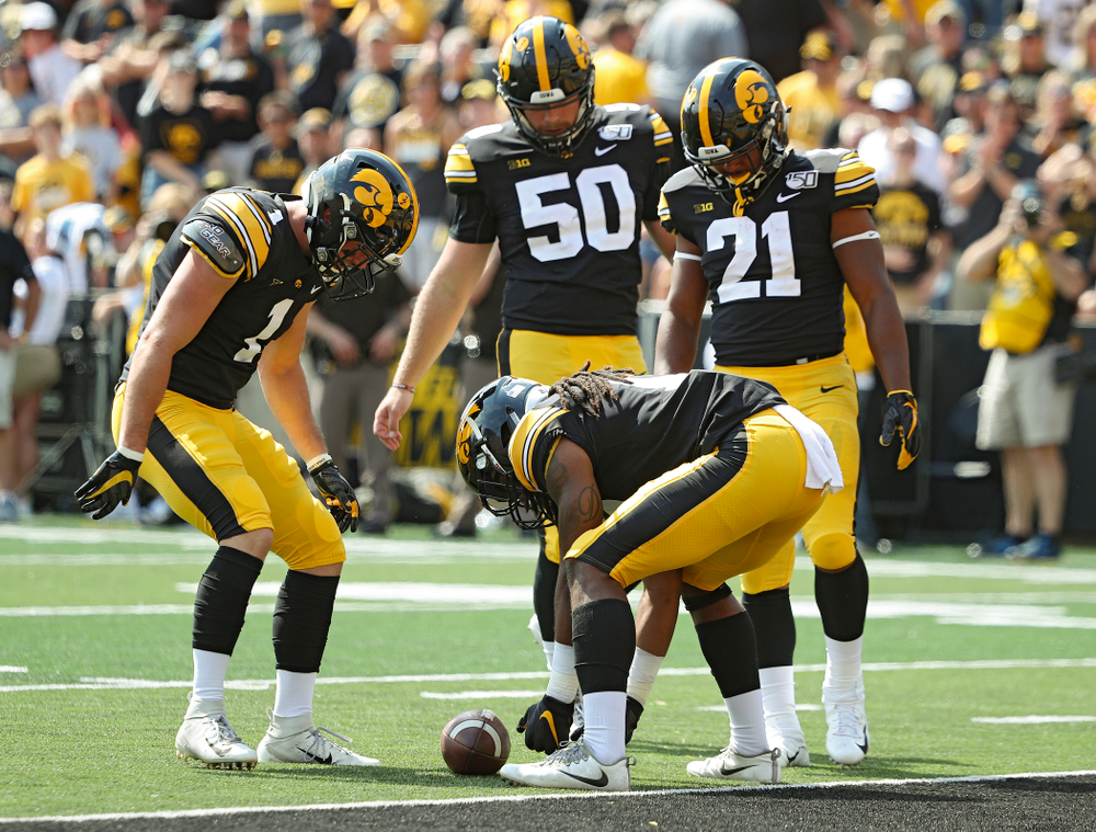 Iowa Hawkeyes defensive back Wes Dvorak (1), long snapper Jackson Subbert (50), and running back Ivory Kelly-Martin (21) gather around as defensive back Devonte Young (17) downs a punt at the 1-yard line during the fourth quarter of their Big Ten Conference football game at Kinnick Stadium in Iowa City on Saturday, Sep 7, 2019. (Stephen Mally/hawkeyesports.com)