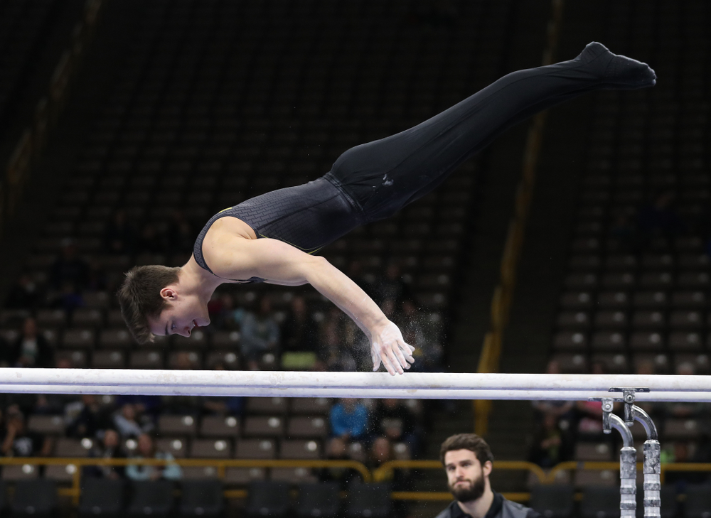 Iowa's Mitch Mandozzi competes on the parallel bars against the Ohio State Buckeyes Saturday, March 16, 2019 at Carver-Hawkeye Arena. (Brian Ray/hawkeyesports.com)