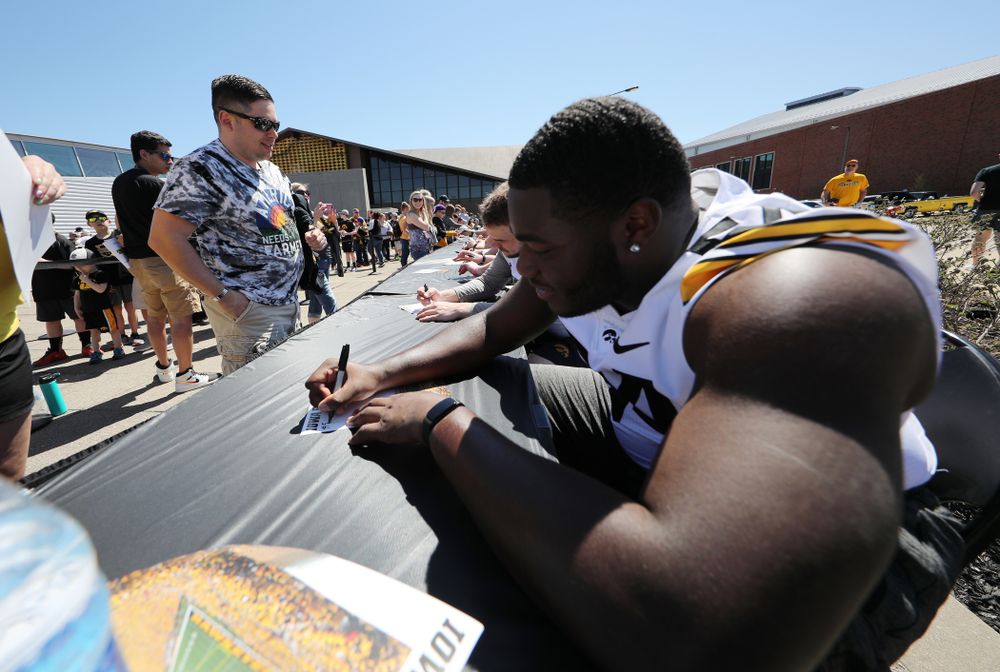 Members of the Iowa Football team sign autographs before the Iowa Hawkeyes game against the Nebraska Cornhuskers Saturday, April 20, 2019 at Duane Banks Field. (Brian Ray/hawkeyesports.com)