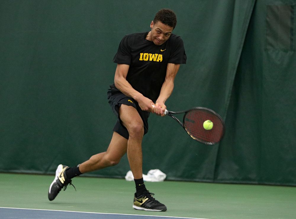 Iowa’s Oliver Okonkwo returns a shot during his singles match at the Hawkeye Tennis and Recreation Complex in Iowa City on Friday, March 6, 2020. (Stephen Mally/hawkeyesports.com)