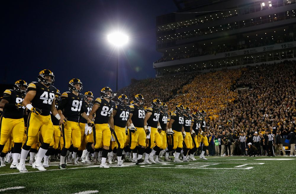 The Iowa Hawkeyes football team swarms the field before a game against Wisconsin at Kinnick Stadium on September 22, 2018. (Tork Mason/hawkeyesports.com)