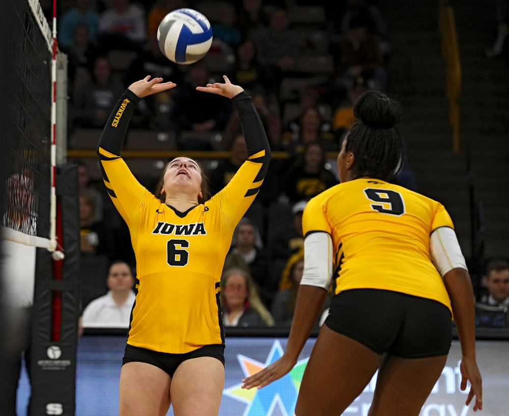 Iowa’s Emma Lowes (6) sets the ball as Amiya Jones (9) looks on during the first set of their match at Carver-Hawkeye Arena in Iowa City on Friday, Nov 29, 2019. (Stephen Mally/hawkeyesports.com)