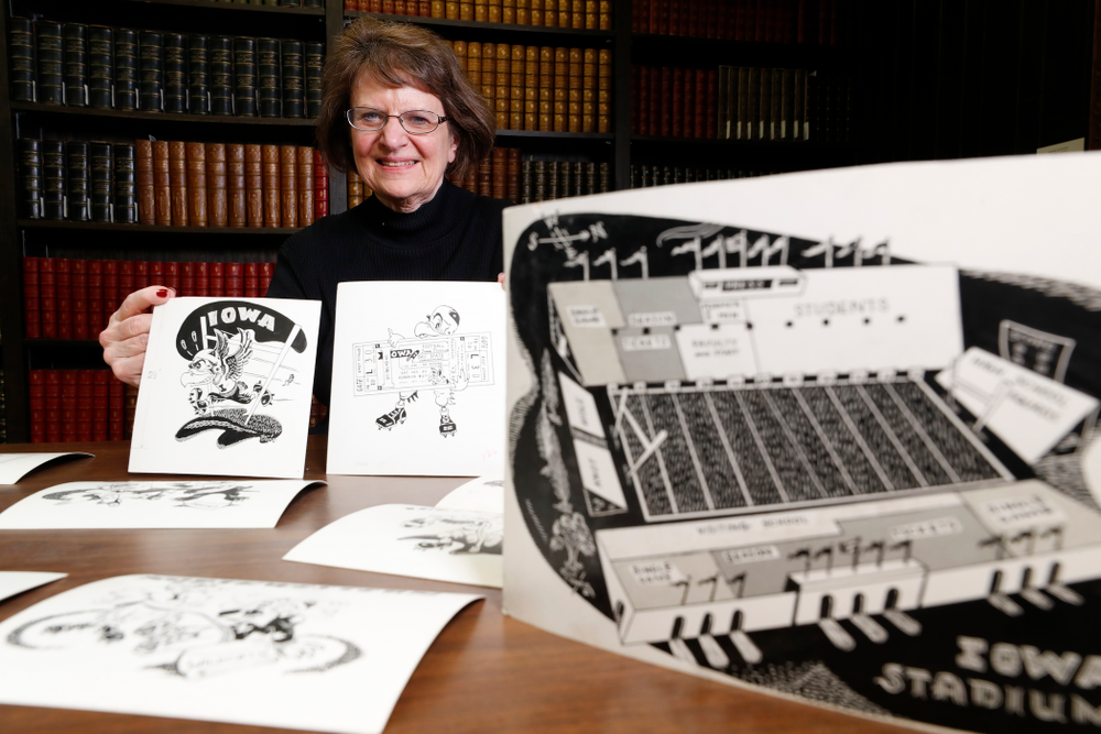 Jane Roth sits with some of the original drawings of Herky the Hawk Friday, April 20, 2018 at the University of Iowa Library. Roth has donated the drawings, which were created by artist Dick Spencer, to the library's special collection. (Brian Ray/hawkeyesports.com)