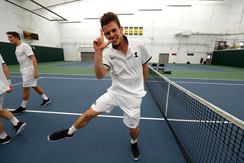 Iowa's Piotr Smietana celebrates with his teammates after clinching the match against Purdue Sunday, April 15, 2018 at the Hawkeye Tennis an