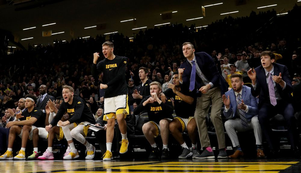 Iowa Hawkeyes guard Austin Ash (13) pumps his fist on the bench against the Michigan Wolverines Friday, January 17, 2020 at Carver-Hawkeye Arena. (Brian Ray/hawkeyesports.com)